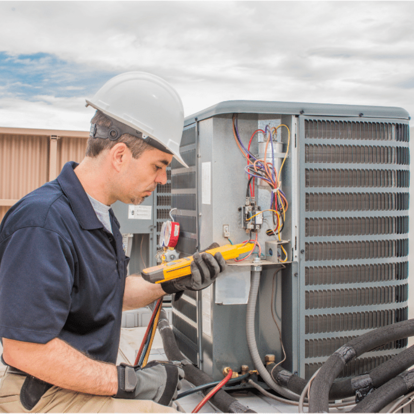 Markham Heating & Cooling HVAC technician servicing a system