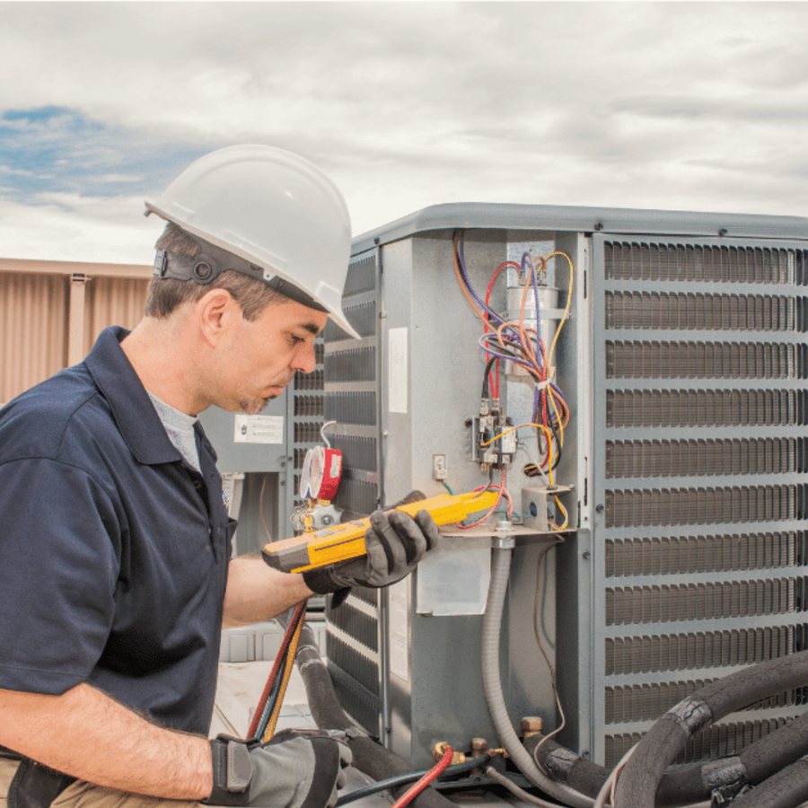 Markham Heating & Cooling HVAC technician servicing a system